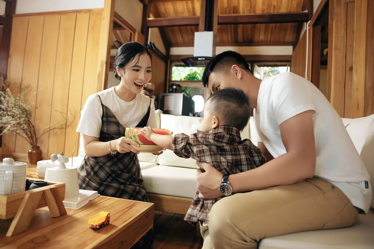 A family with a small child in a cosy living room.